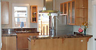Custom Fir cabinets with marble counter tops, island vent hood and breakfast bar